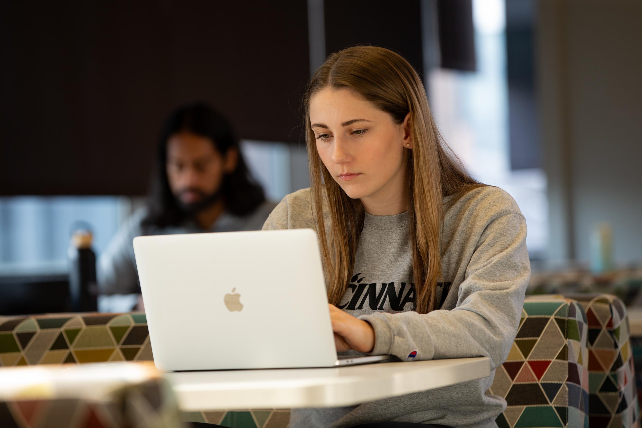women sitting in front of laptop
