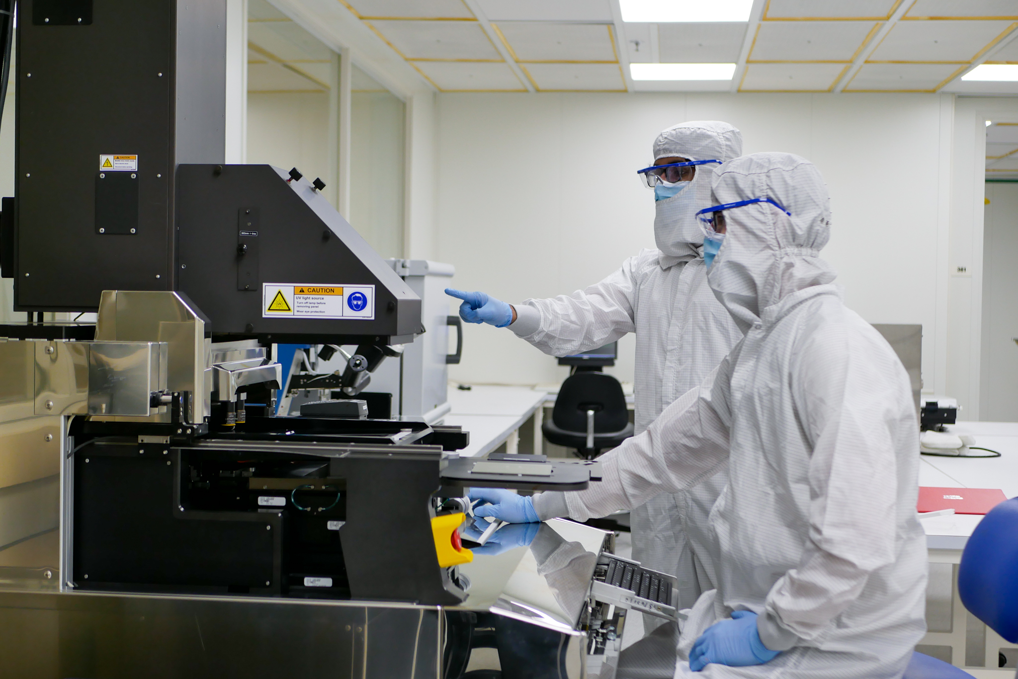 Two people stand in the cleanroom